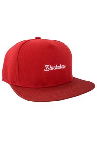 Red snapback cap made of textured fabric. Features a flat brim and embroidered "Blackskios" logo in white on the front panel.
