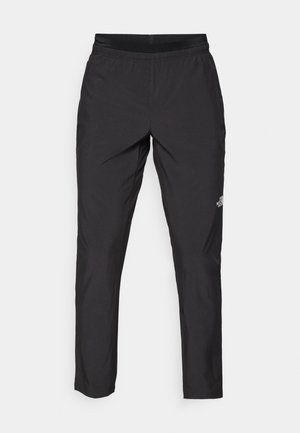Pantaloni sportivi neri con cintura elastica, realizzati in tessuto leggero, con un piccolo logo sulla parte inferiore della gamba e una linea dritta.