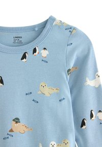 Jasnoniebieski bodziak z długim rękawem z różnymi ilustracjami fok i pingwinów, zatrzaski na ramieniu oraz miękka bawełniana faktura.