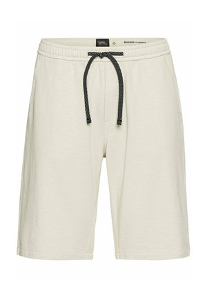 Cremefarvede afslappede shorts lavet af blødt stof, med en drawstring-talje og en sort-hvid mønstret snor.