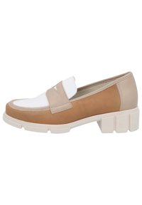 Tan and cream slip-on loafers with a block heel; smooth leather upper, featuring a white cap toe and strap detail across the vamp.