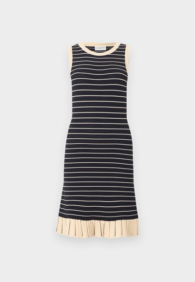 Μαύρο και μπεζ πλεκτό φόρεμα χωρίς μανίκια με οριζόντιες ρίγες, μπεζ τελείωμα στα ανοίγματα των χεριών, στον λαιμό και στο πλισέ τελείωμα.