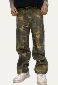 Pantaloni cargo in motivo mimetico, realizzati in tessuto resistente, con tasche laterali, taglio dritto e una combinazione di tonalità verdi e marroni.