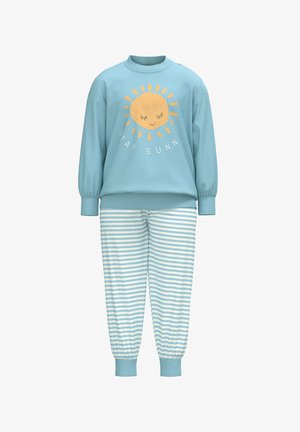 Light blue sweatshirt with a sun graphic and "STAY SUNN" text, paired with striped light blue and white pajama pants. Cuffed sleeves and ankles.