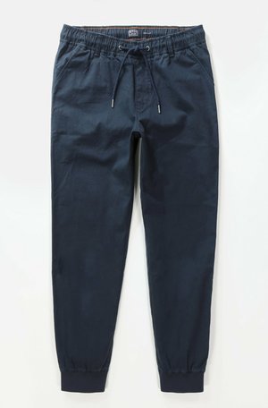 Pantalones jogger azul marino fabricados con una mezcla de algodón, con cinturilla elástica, cordón ajustable y puños en forma de cono. Incluye dos bolsillos laterales.