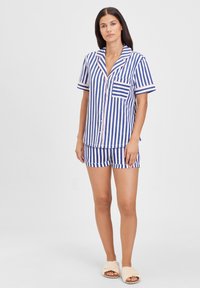 Short-sleeve striped pajama set featuring blue and white vertical stripes with pink accents, a collar, and a chest pocket. Shorts included.