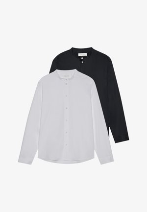 Two long-sleeve shirts in white and black. Both feature a rounded collar, button closures, and a smooth, fitted design.