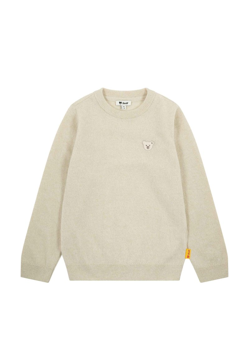 Beige Strickpullover mit Rundhalsausschnitt, langen Ärmeln und einem kleinen Bären-Patch auf der Brust. Enthält ein gelbes Markenschild an der Seite.