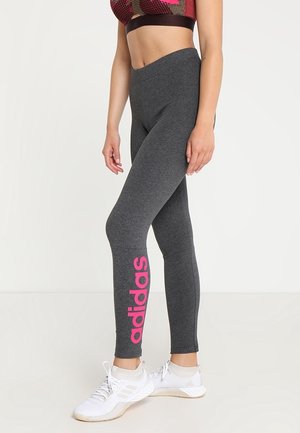 Gray leggings made of stretchy fabric, featuring a prominent pink adidas logo on the side. Paired with white athletic shoes.