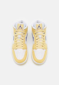 Hög-topp sneakers med en gul och vit färgkombination, perforerad tåsko, vadderad krage och blå accenter med en logotyp på tungan.