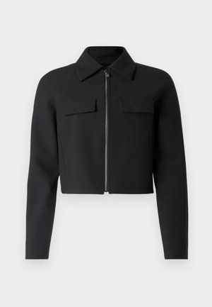 Black cropped jacket with a zip front, long sleeves, and two chest pockets; made from smooth, textured fabric.