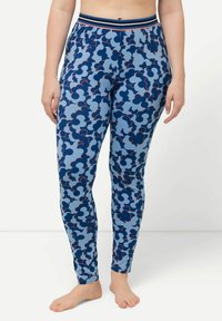 Blå tights med ett molnmönster i mörkare blått och röda detaljer, samt ett tjockt randigt midjeband. Tillverkade av ett stretchigt tyg.