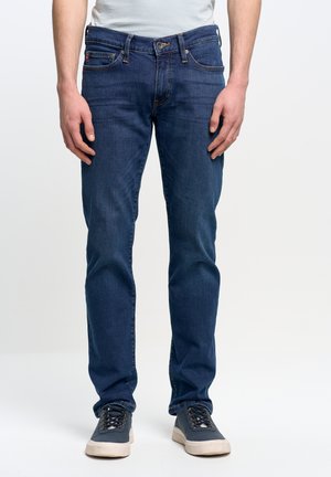 Dunkelblaue Jeans aus Denim im Slim-Fit, mit einem traditionellen Fünf-Taschen-Design, kupferfarbener Stickerei und einem Knopfverschluss.