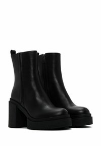 Black leather ankle boots with a chunky platform and block heel. Features a side zipper and pull tab for easy wear. Smooth texture, modern design.