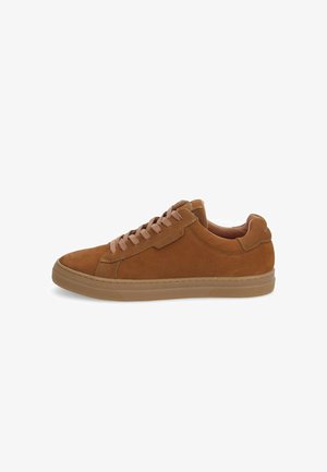 Brown suede sneaker with a low profile, textured upper, round toe, and lace-up closure. Rubber sole with patterned tread for grip.
