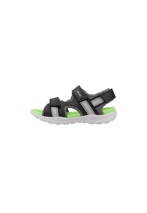 Sandalia negra y gris con dos correas ajustables, plantilla verde y suela blanca. Cuenta con malla transpirable y detalles de goma.