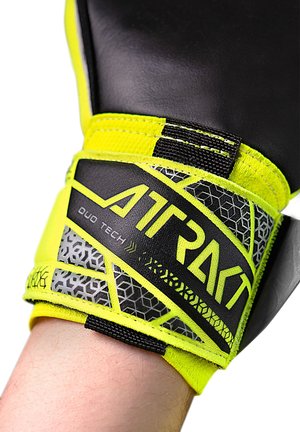 Black and neon yellow boxing glove with a textured design, featuring a hexagonal pattern on the wrist strap and "DUO TECH" branding.