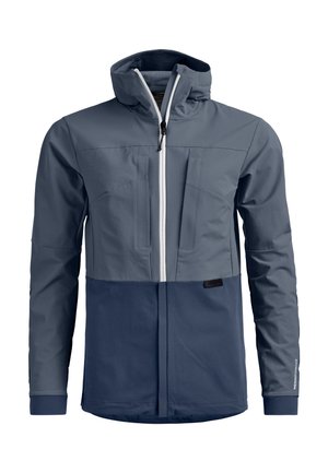 Men’s two-tone navy blue softshell jacket with front zipper, high collar, chest pockets, and long sleeves.
