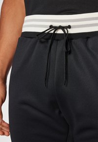 Fila PANTS BAME - Spodnji deli trenirk - black/white alyssum