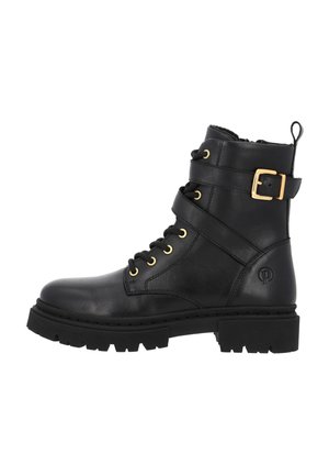 Black leather ankle boots with gold hardware, laces, and a buckle detail. Thick textured sole and logo accent on the side.