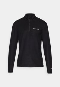 Chaleco negro de media cremallera con mangas largas, fabricado en un tejido suave, que cuenta con un pequeño logo blanco en el lado izquierdo del pecho y detalles en los puños.
