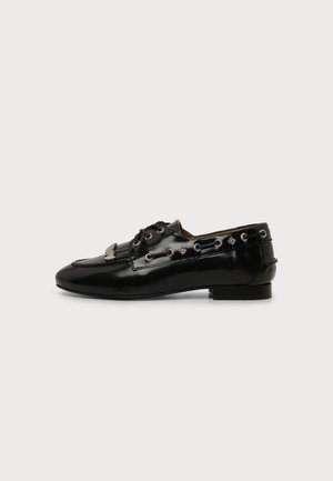 Glossy black leather loafer with lace-up details, fringe on top, and metal eyelets along the sides, viewed from the outer side.
