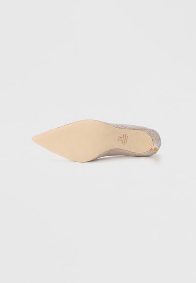 Pointed-toe shoe with a metallic, woven upper in light beige, featuring a smooth beige outsole and subtle branding on the insole.