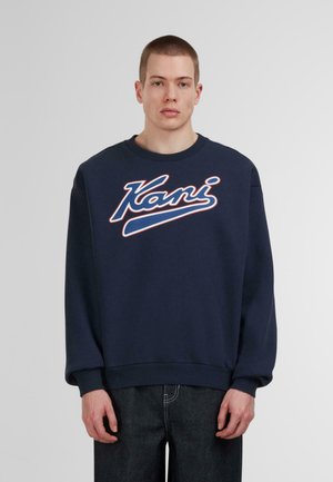 Navy blue sweatshirt made of cotton, features a curved white and blue logo "Kani" on chest, ribbed cuffs and hem, with a relaxed fit.