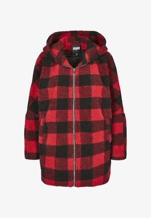 Piros-fekete kockás polárdzseki kapucnival, elülső cipzárral és két oldalzsebbel. Puha tapintású és bő szabású.