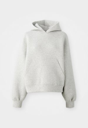 Haut à capuche gris clair avec une poche kangourou à l'avant, cordon de serrage à la capuche et poignets côtelés. Tissu doux et texturé, coupe oversize.