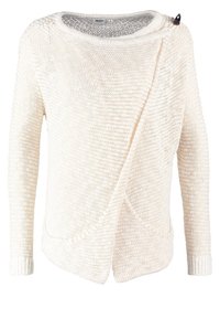 Pull en tricot crème avec une finition texturée, coupe surdimensionnée, design asymétrique et un seul bouton d'accent noir près de l'épaule.