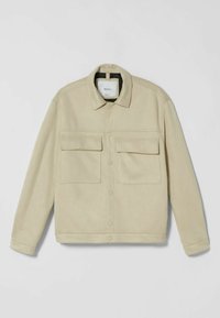 Beige jacket made of soft fabric featuring a collared neck, button front, two chest pockets, and visible stitching details.