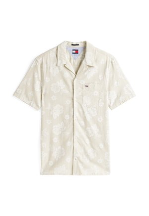 Camicia a maniche corte con colletto in beige chiaro con motivo floreale bianco. Presenta una tasca frontale e un logo del marchio discreto sul petto.