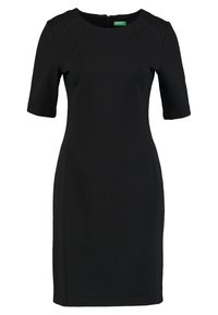 Musta mekko lyhyillä hihoilla, pyöreällä kaula-aukolla ja istuvalla siluetilla. Valmistettu sileästä kankaasta, jossa on takana vetoketju.