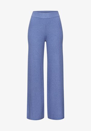 Siniset neulotut leveälahkeiset housut, joissa on korkea joustava vyötärö. Ne ovat pehmeät ja mukautuvat löysällä istuvuudellaan mukavuuteen.