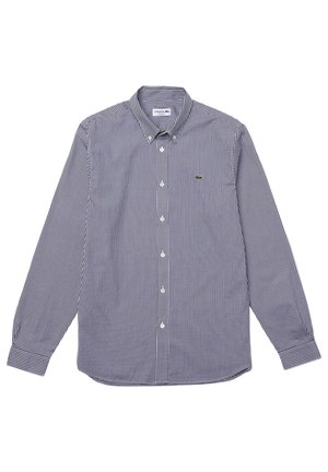 Langarmshirt in marineblauw en wit geruit patroon, gemaakt van geweven stof. Heeft een spitse kraag, knoopsluiting en een klein logodetail.