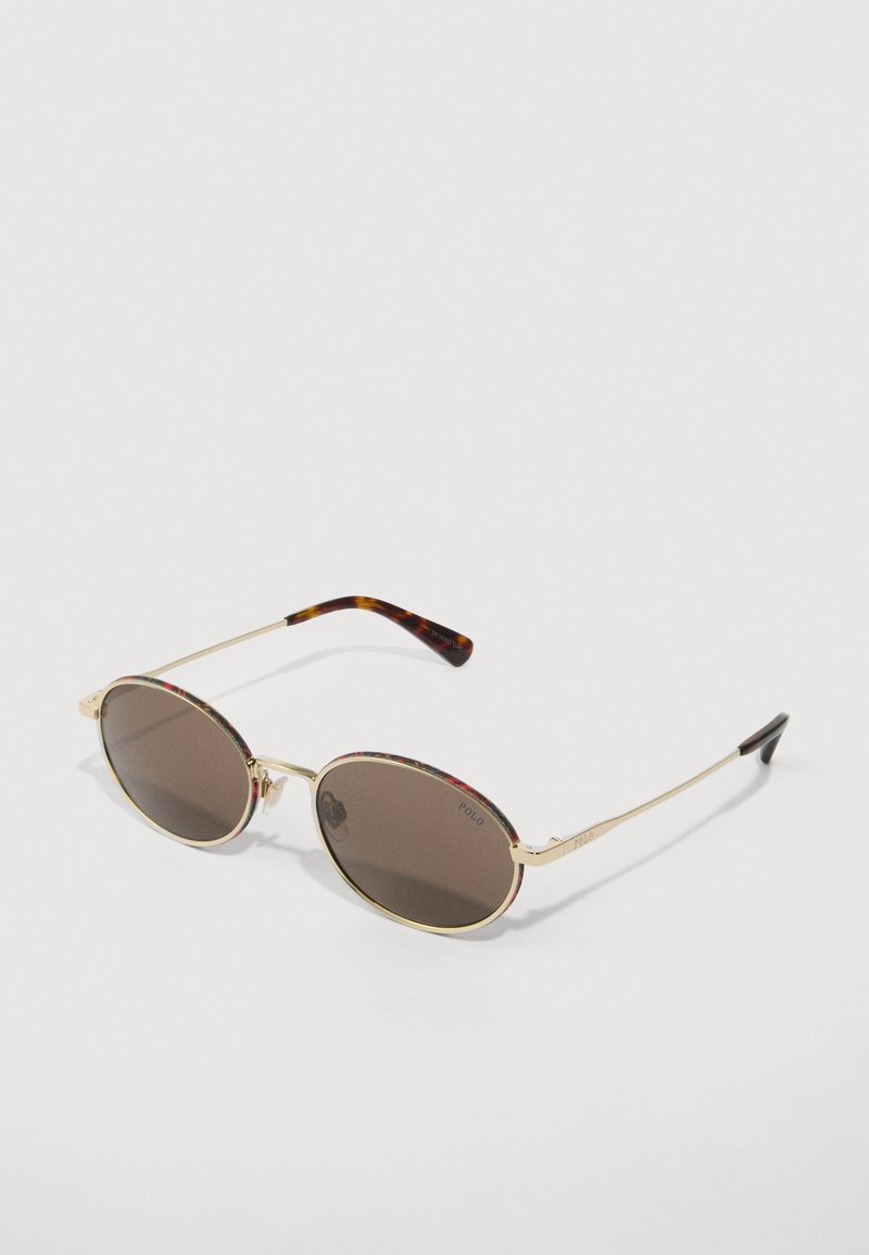 Sunglasses with oval brown lenses, gold metal frame, and multicolored floral accents on the brow and arms, featuring a tortoiseshell tip.