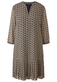 Robe à motifs en noir et beige, avec un col en V, des manches longues et un ourlet plissé. Fabriquée en tissu léger avec un design géométrique.