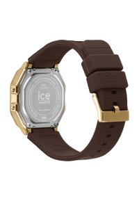 Montre-bracelet en silicone brun avec un boîtier octagonal en acier inoxydable doré et un dos de boîtier en argent, équipée d'une fermeture à clip.