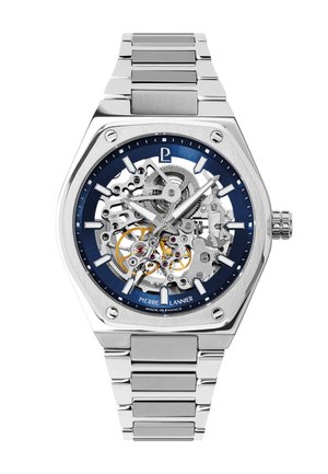 Silver stainless steel wristwatch with skeleton dial showing gears, blue outer ring with hour markers, and silver link bracelet.