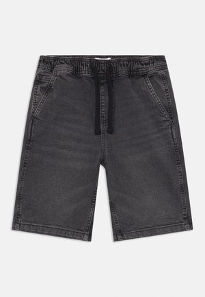 Calças de ganga cinzentas com uma cintura elástica e cordão. Possui dois bolsos laterais e uma textura suave.
