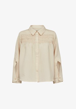 Kerge beez värvi nööpidega särk, millel on krae ja smockitud kehaosa ning pikad varrukad. Kangas on kergelt soonikline.