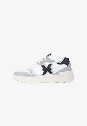 White and gray low-top sneaker with black logo on side, white laces, and thick off-white sole, viewed from the outer side.