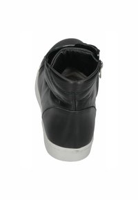 Black leather ankle boot with a rounded toe, zip closure, textured surface, and white rubber sole.