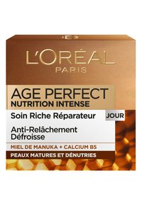 Boîte de crème L'Oréal Paris AGE PERFECT NUTRITION INTENSE ; design doré et blanc avec du texte ; présente un motif de nid d'abeille ; forme carrée.
