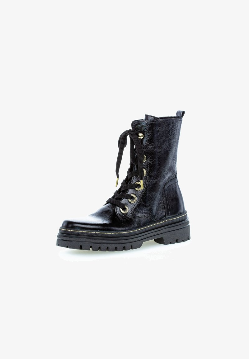 Bottes de cheville en cuir noir avec une finition brillante, devant à lacets, œillets dorés, semelle en caoutchouc épaisse et tige texturée.