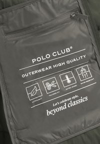 Polo Club ytterklädsetikett med ficka med dragkedja, ikoner för ultralätt, skräddarsydd passform, extra varm, vattenresistent och slogan beyond classics.