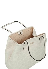 Borsa a mano bianca trapuntata in materiale di pelle, con manici scuri in contrasto e un'interno beige rivestito con un motivo a logo ripetuto.
