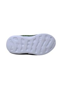 Suola di sneakers bianche con motivo a onde testurizzato e scanalature di flessione, con un accento verde lungo il bordo. Finitura liscia.