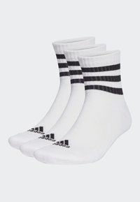 Weiße Knöchelsocken mit schwarzen horizontalen Streifen am oberen Rand und schwarzem "adidas"-Logo auf der Sohle. Hergestellt aus weichem, dehnbarem Stoff.